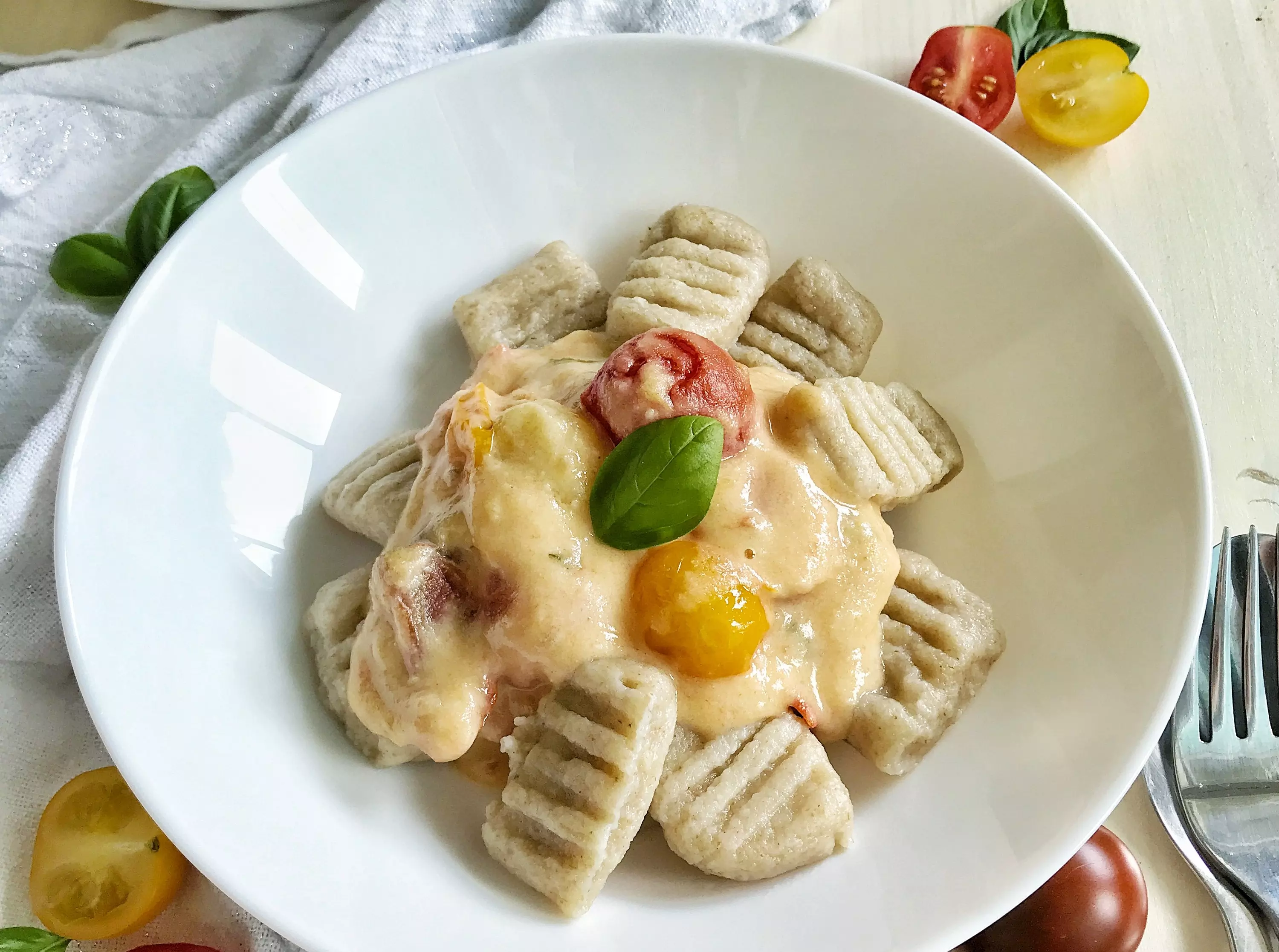 Semolina gnocchi in coconut sauce with tomatoes